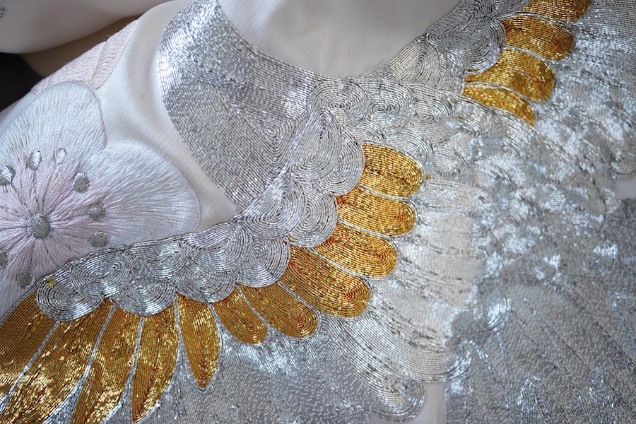 A Japanese pale pink silk floral and metallic thread bird embroidered wedding kimono, 184cm long.